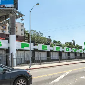 Exterior facade of Silverlake Speedwash on Beverly Blvd, showcasing the bright green branded signage—making the location easily visible and attractive to passersby in the vibrant Silverlake community.