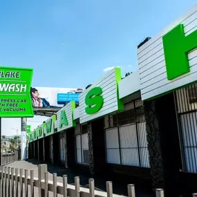 Iconic Silverlake Speedwash facade on Beverly Blvd, featuring high-visibility green signage and a street-facing promo board offering 5-minute express washes with free vacuums—an eye-catching, trusted destination in East LA.