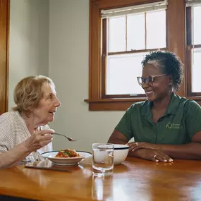 Care Professional and client enjoying a meal together.