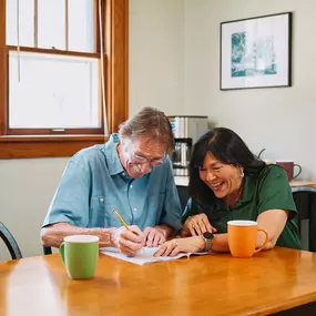 Care Professional and client writing a letter.