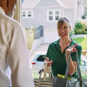 Care Professional bringing groceries into a clients home.