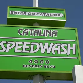A clear, close-up view of the Catalina Speedwash signage showing the location’s bold green branding, address (4000 Beverly Blvd), and directional arrow labeled 