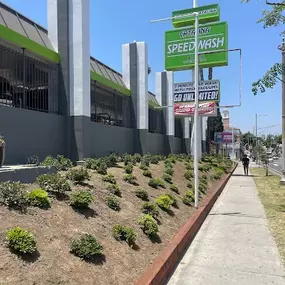 This angled sidewalk shot showcases urban approachability and walk-up branding. Strong for location context and neighborhood integration.