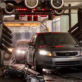 This vivid tunnel shot emphasizes cutting-edge wash tech with visual energy. Highlights equipment investment and high capacity.