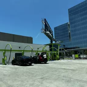 Outdoor vacuum lanes at Olympic Speedwash, with multiple bays and ample parking space, situated near modern commercial buildings—perfect for post-wash vacuuming and detailing.