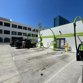 Olympic Speedwash exterior featuring branded lime‑green self‑service vacuum bays, standout arches, and hose stations, showcasing the clean, user‑friendly setup ideal for quick interior detailing.