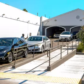 Vehicles exiting the Olympic Speedwash express tunnel in West LA, where team members help with final touches. This high-volume location offers efficient service, modern vacuum stations, and fast turnaround—perfect for busy drivers on the westside.
