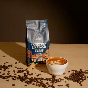 bag of coffee espresso Italiano next to a latte and coffee beans on a wooden table