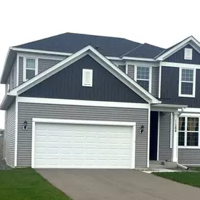 Recently completed home exterior project featuring seamless gutter replacement.