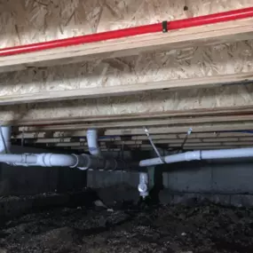 Expert rough-in plumbing work completed by Just Plumbing, Inc. in a crawl space for long-lasting performance.