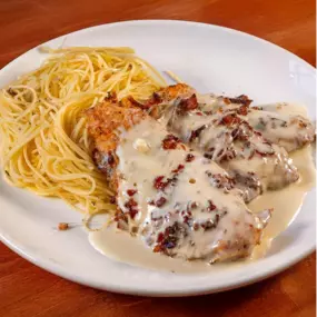Sinatra Chicken: Pan seared chicken breast, pancetta, mozzarella, Grand Marnier cream sauce, herbed capellini