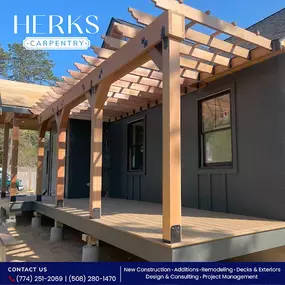 Craftsmanship meets design. A custom-built pergola and deck by Herks Carpentry, adding both shade and style to this modern exterior.