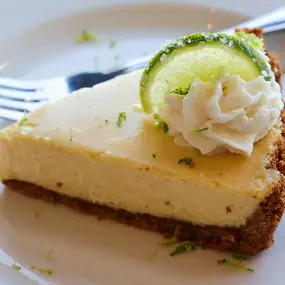 Key Lime pie topped with fresh whipped cream.