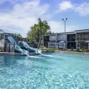 The outdoor pool with two slides at Orbit One Vacation Villas