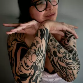 Abstraktes Blackwork Sleeve Tattoo mit floralen Mustern.