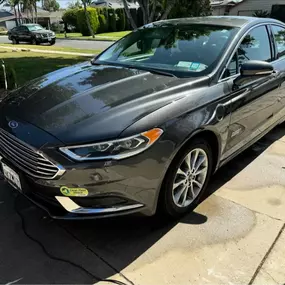 Sleek gray Ford sedan with a flawless, polished exterior finish, reflecting the expert exterior detailing and paint protection services by Ozzie’s Mobile Detailing in Long Beach, CA.