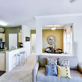 Open concept living room that attaches to the kitchen island and barstool seating