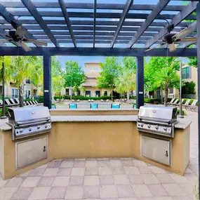 Outdoor grilling area with a blue covering
