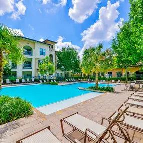 Outdoor pool with white lounge chairs