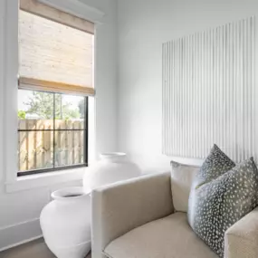 Woven Wood Shades bring warmth and natural texture to this cozy corner, softly filtering light while adding an organic touch to the space