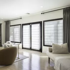 Roman Shades and Drapery Panels create a timeless, layered look, offering soft light diffusion and elegant texture while enhancing privacy and style.