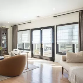 Light-filtering Roman shades paired with beautiful draperies elevate any room, creating the perfect ambiance with optimal light control and privacy.