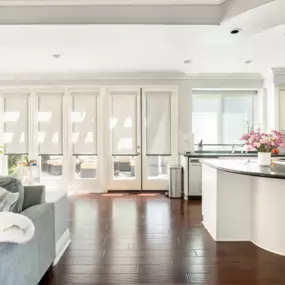 Roller shades installed in a bright, open kitchen space
