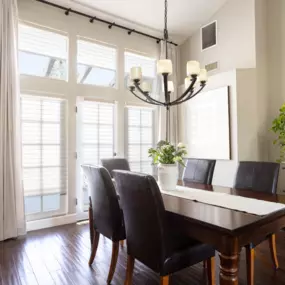 Motorized drapes & shades in a dark and moody dining room