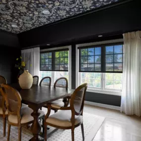 Embrace the dark and moody trend with our stylish window treatments. Our energy efficient solar shades not only enhance your décor but also keep your dining room comfortable for entertaining guests.
