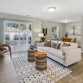 an open living room with a white couch and a rug