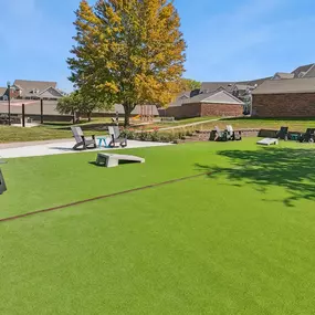 a park with picnic tables and benches on the grass