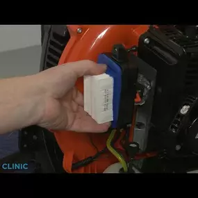 A close up of a technician replacing the air filter on an Echo leaf blower, showcasing small engine repair