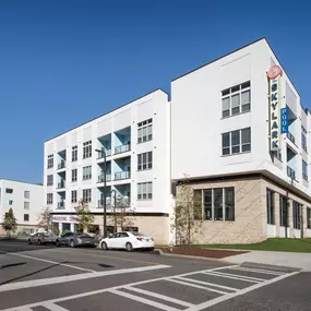 Front entrance of Skylark Apartments in Atlanta featuring modern architecture, landscaped entryway, and welcoming community design.