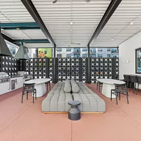 Outdoor lounge and grilling area at Skylark Apartments in Atlanta with modern seating, stainless steel grills, and social dining spaces.