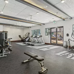 Luxury apartment community fitness center featuring cardio equipment and strength training area.