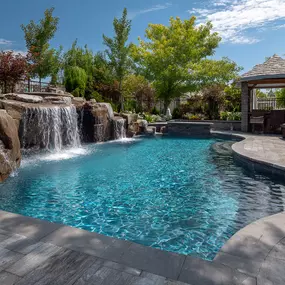 Custom gunite pool installation with rock waterfall