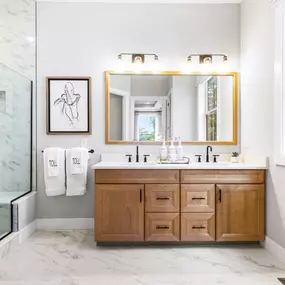 Spa-like primary bathroom with dual sink vanities and luxe showers with sinks