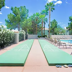 Poolside shuffleboard area with pool in the background