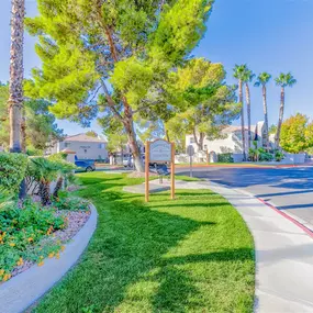 Outdoor walking area with welcome signage and green grass