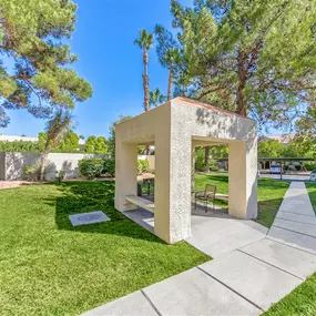 Gazebos and community picnic area with seating and a BBQ grill