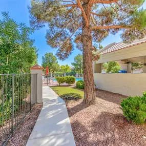 Walking path through shaded area next to apartments