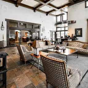 Interior of leasing office with soaring ceilings, tall windows, wooden beams, and lounge area