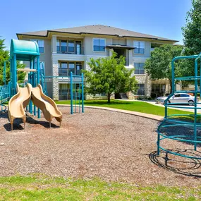 Blue and yellow playground with bark flooring
