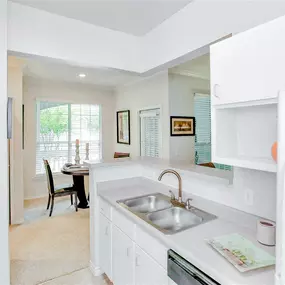Kitchen with white cabinets and appliances