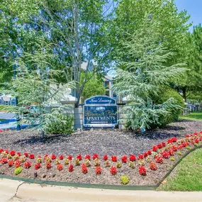 Property sign with red flowers