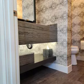 Elevating this powder room from simple to stunning, The Wallpaper Co - North Scottsdale delivers a flawless wallpaper installation that adds rich texture and depth to the space. The abstract pattern blends effortlessly with the modern wood tones and sleek stone finishes, creating a luxurious yet inviting vibe. Every detail reflects the expert craftsmanship and eye for design that make this team a standout in transforming interiors.