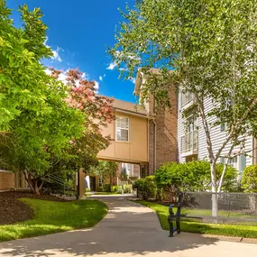 A residential area with a building and a tree at Prairie Commons - 55+ Senior Community Apartments, Lawrence, KS, 66049