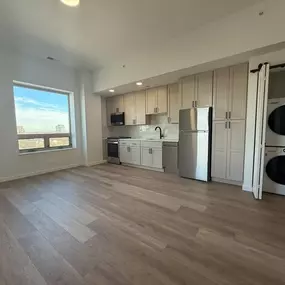 A kitchen with a refrigerator, microwave, and oven is shown.at The Nest at Lincoln Park West, Illinois