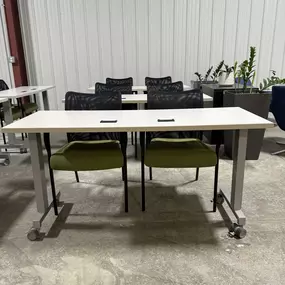 Rolling tables set up in a training room area