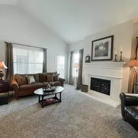 Living room with beige carpeting and fireplace